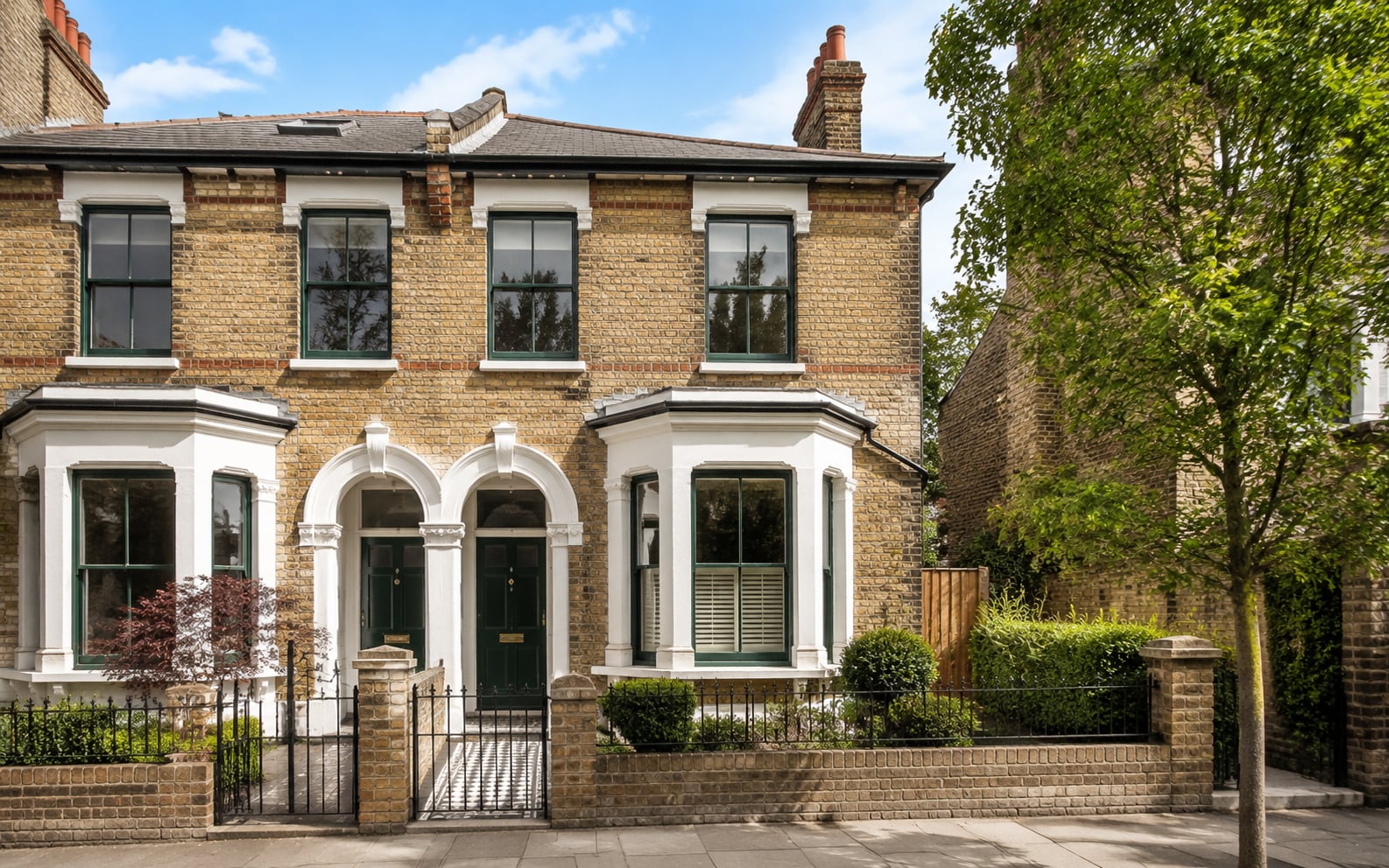 Yellow stock brick Victorian semi-detached house in Tunbridge Wells with fir green timber sash windows and a matching green door